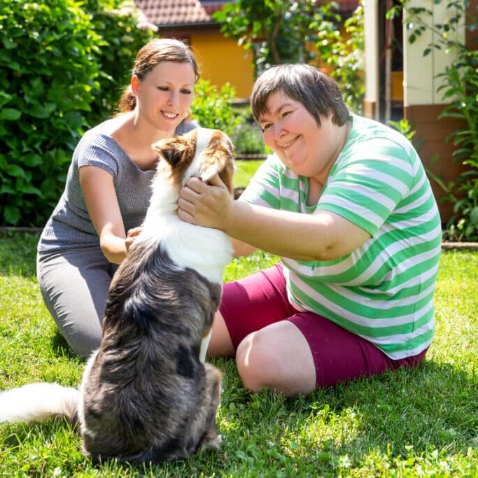 Mentally Disabled Woman With A Second Woman And A Companion Dog
